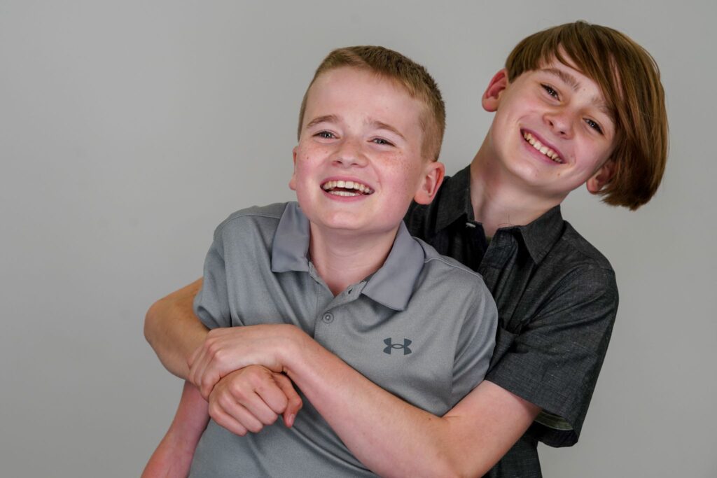 Young brothers smiling and hugging