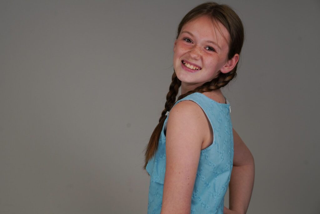 Young girl wearing braids smiling