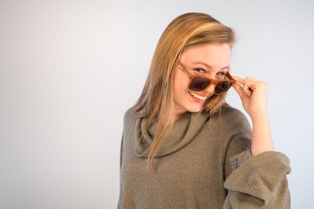 Teen girl wearing sunglasses and smiling